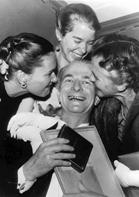 Holding his first Nobel medal, surrounded by family members